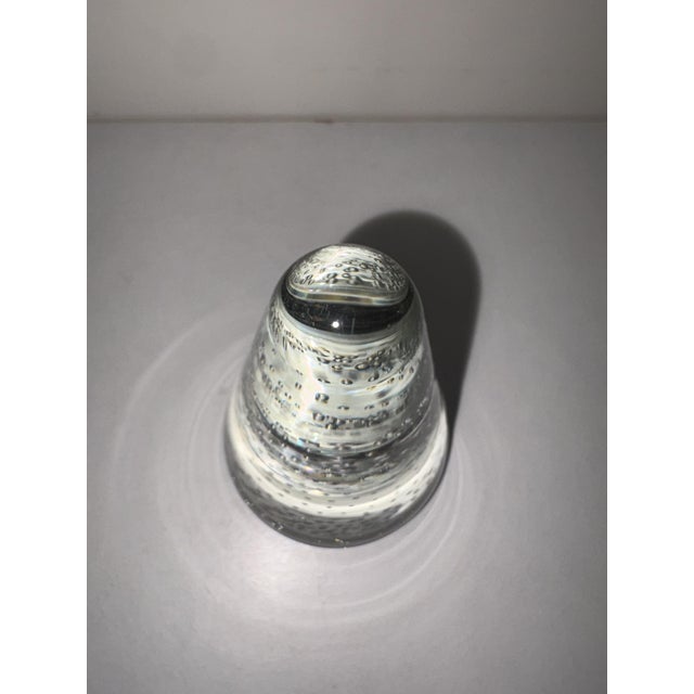 Clear glass paperweight in the shape of a cone with trapped air bubbles, height 12 cm, circumference 7 cm
