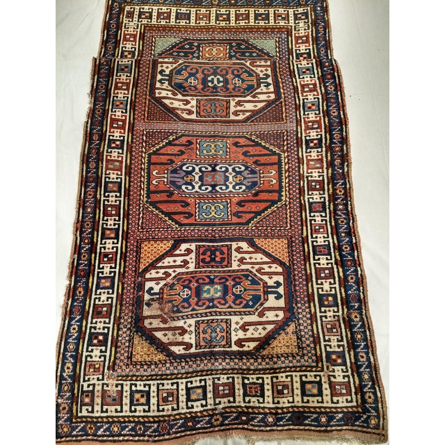 3’ 8” X 6’ 3” A triple medallion Karachov Kazak area rug from the Caucasus region woven in the 4th quarter of the 1800s....