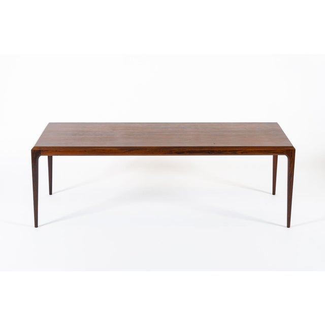 This exquisite Danish modern rosewood coffee table was designed by Johannes Andersen for CFC Silkeborg and made in Denmark...