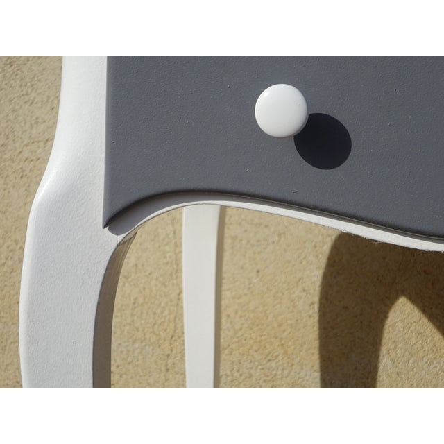 A 1970s dressing table in solid wood, restored and painted white. The central section opens to reveal a mirror on a...