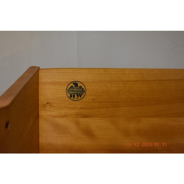 Authentic Heywood-Wakefield design Mid-century modern styling Warm champagne/honey wheat finish Sculpted drawer fronts...