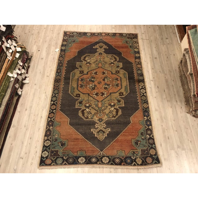 This is a vintage Turkish Oushak rug from the 1960s. The piece was hand-knotted.