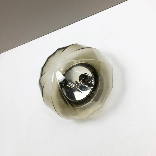 This 1970s modernist german wall light is made of high-quality green glass in a cubic form with a solid metal chromed wall...