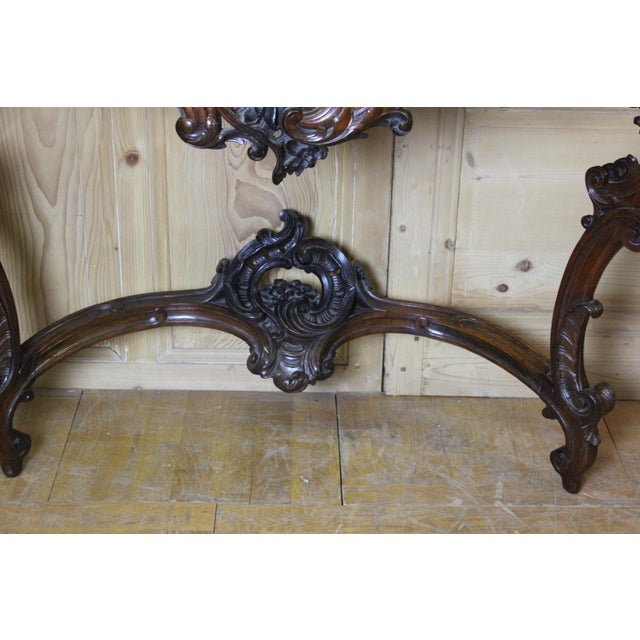 A long Louis XV style walnut console table from the 19th century, with a light grey marble top veined with black. It is...