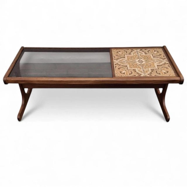 The g plan coffee table is a stunning mid century table that combines a smoked glass top with patterned ceramic tiles,...