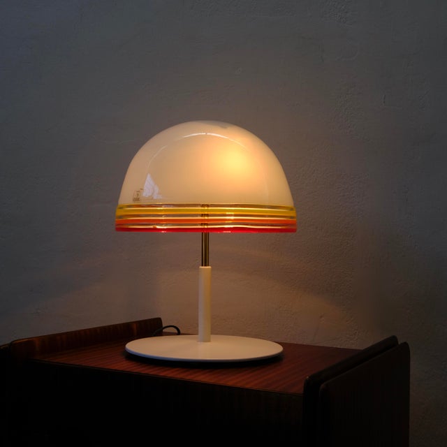 The Febo table lamp, a masterpiece of 1970s Italian lighting design. The hemispherical dome shade is made of fine, hand-...
