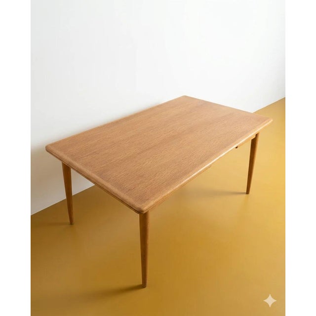 Vintage Danish oak table from the 1960s with two butterfly extension leaves, an elegant design with rounded corners,...