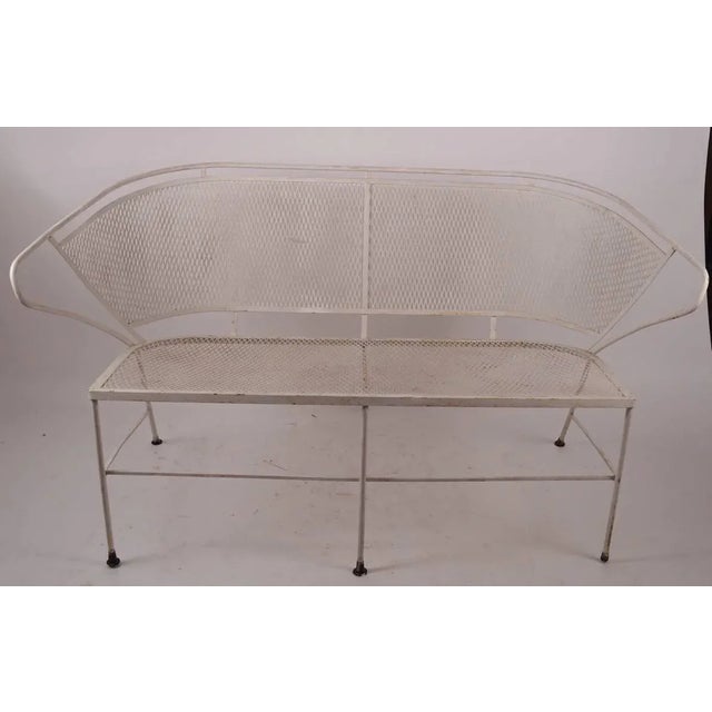 Interesting wrap around backrest metal mesh and wrought iron settee, attributed to Woodard Furniture Company. Mesh seat...
