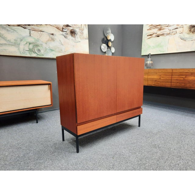 Here is a rare teak highboard by Dieter Wäckerlin from the 1960s. Minimalist design. Manufactured by Erwin Behr,...