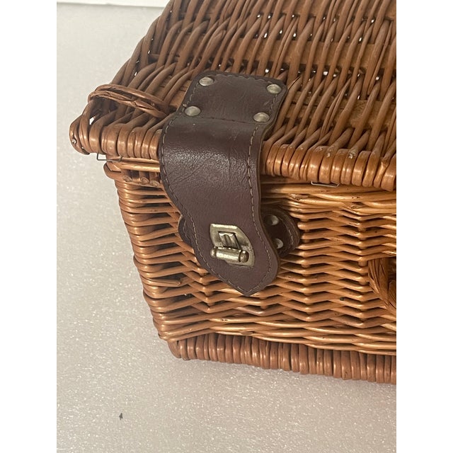 Vintage handmade rattan basket with leather accents. For picnic or storage.