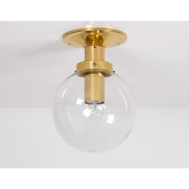 Flush mount glass globe light model T472 in brass by Hans-Agne Jakobsson, 1970s. 25 available. Measure: Height: 35 cm....