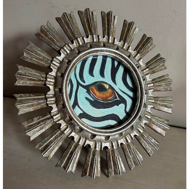 Original acrylic painting of a zebra eye in small, tabletop, silver, round, wood starburst frame. Features a close up of a...