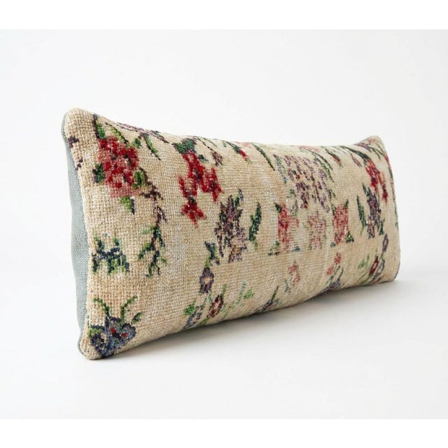 This beautiful 13'' x 46'' pillow cover was made from an authentic Turkish rug. Bright colors of wool adorn the front of...