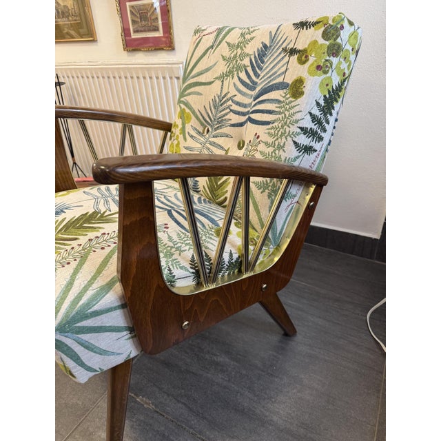 1950s armchair Impresses with its floral fabric upholstery and striking wooden armrests Woodwork refurbished Newly...