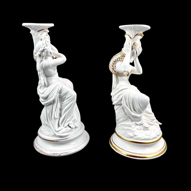 An elegant pair of late 19th-century porcelain figural candlesticks, possibly produced by Sutherland & Sons of Longton,...