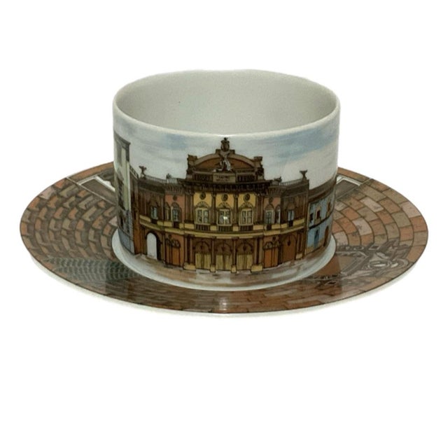 This cup and saucer is from the Città d'Italia group designed by Pietro Fornasetti. This particular set has the Catania...