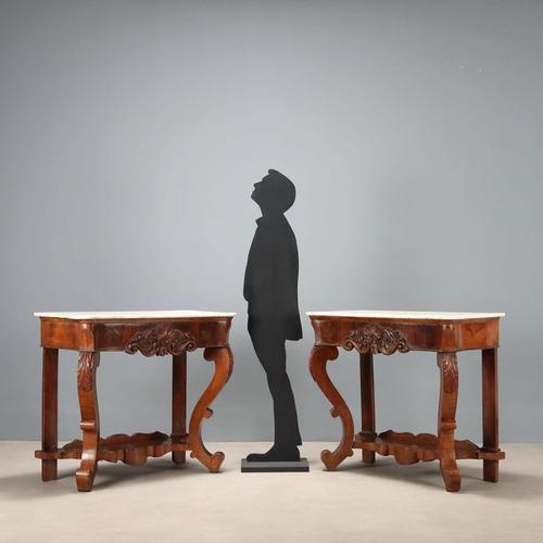 Pair of Louis Philippe mahogany console tables. White marble top, sub-top band with leaf carvings and scrolls, wavy front...
