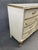 An elegant vintage French Provincial triple dresser featuring its classic cream finish, gilded gold detailing and...