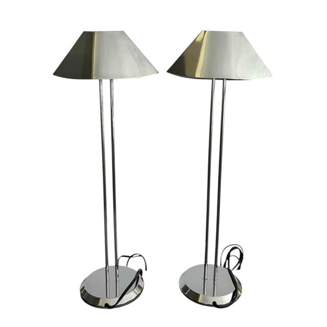 A handsome pair of chromed table lamps that would be great flanking a buffet, side tables or nightstands. High quality...
