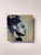 This oil on panel piece captures a striking profile of a figure, characterized by bold brushstrokes that convey both...