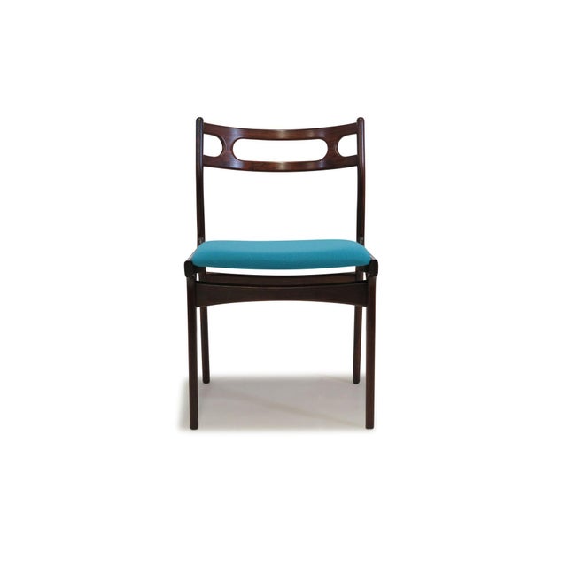 Designed by Johannes Andersen for Uldum Moblefabrik in Denmark, circa 1960, these rosewood dining chairs feature...