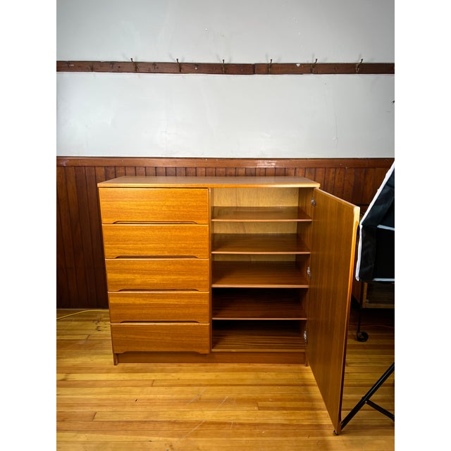 For sale is a vintage chest of drawers, crafted in Denmark, as indicated by the stamp on the back. This dresser combines...