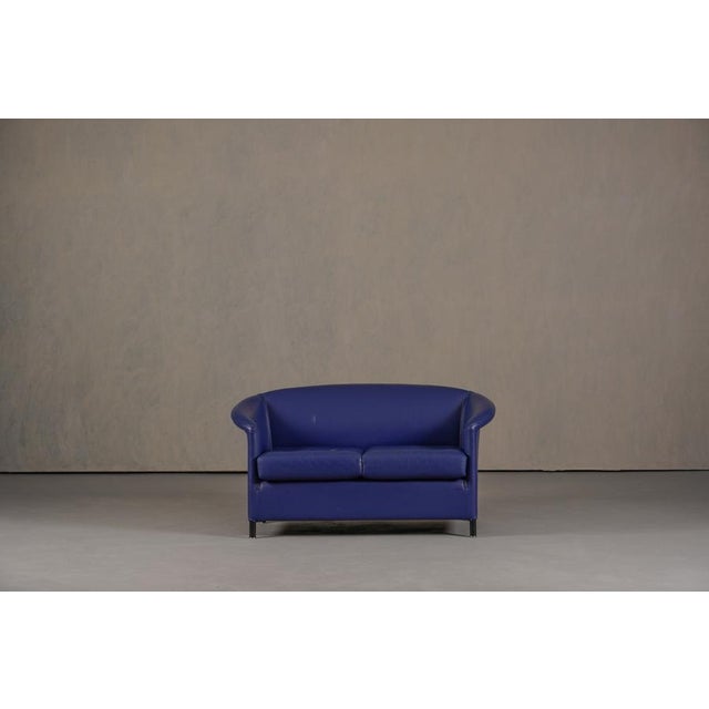 The Aura armchair by Wittmann is upholstered in blue genuine leather and stands on black legs. It is characterized by its...