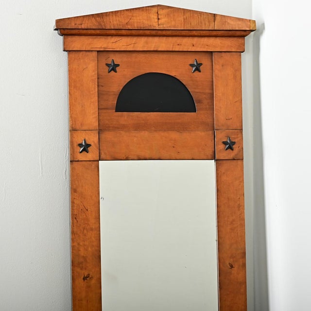 Dimensions: 48 ⅝” H x 24 ¼” W x 2 ⅜” D A fantastic Biedermeier period trumeau from France, 19th century, made of birch...