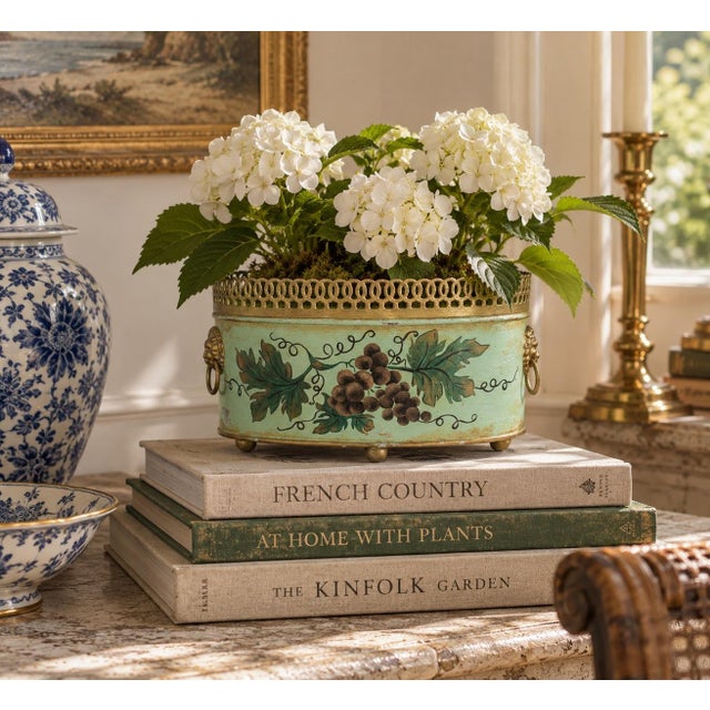 A wonderfully charming mid-20th century French tole cachepot finished in a mint green with delicate gilt embellishments...