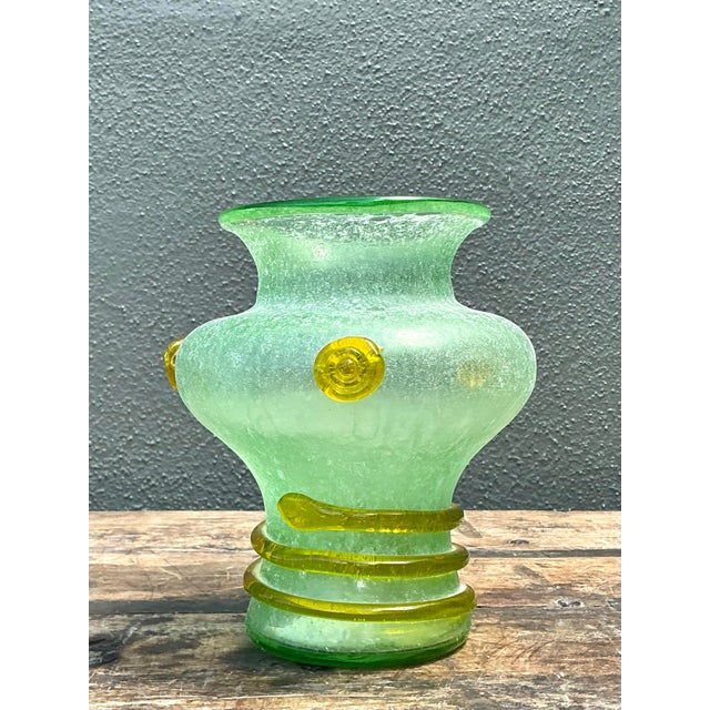 This exquisite vintage Italian hand-blown glass vase is a stunning example of artisanal craftsmanship, likely originating...