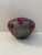 A striking vintage art pottery vessel featuring a low, rounded form with a dramatic metallic raku-style glaze. Deep red...
