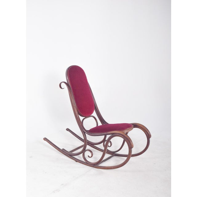 Rocking chair. The structure is made up of sinuous, interwoven pieces in elegant circular and curved shapes, a hallmark of...