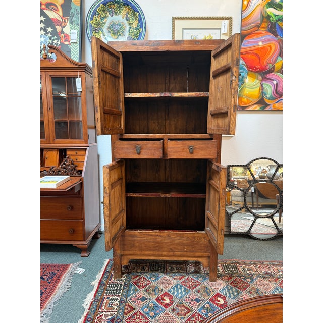 Design Plus Gallery presents a Vintage Chinese Elm Two-Tier Cabinet. Constructed from elm, this tall cabinet showcases...