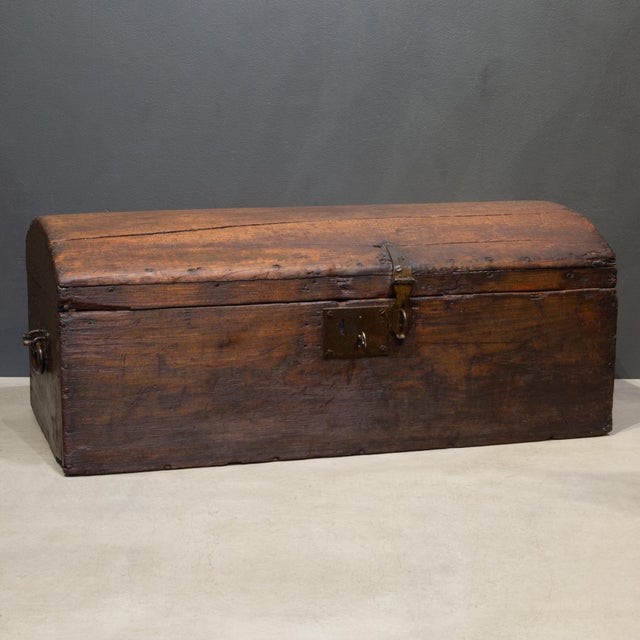 ABOUT An authentic 19th century primitive wooden storage chest featuring a classic dome-top design. This compact piece was...