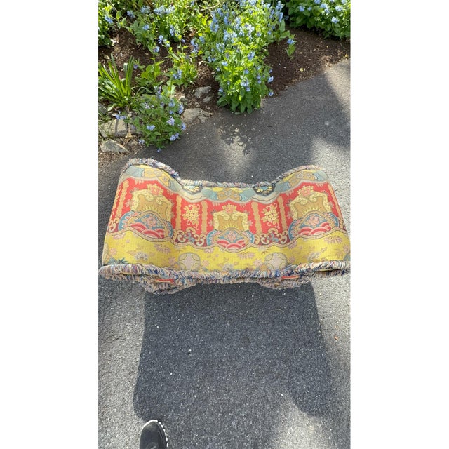 This stool is upholstered with a jacquard-woven tapestry fabric of extremely high quality as is the fringe on the piece....