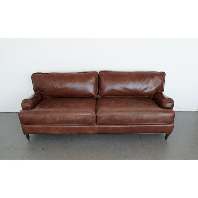 Supple mocha leather steeped in English tradition, this Ballard Designs Wynne Leather Sofa embodies timeless refinement...