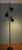 This floor lamp was made in France in the 1950s. It consists of three black lacquered shades, brass tubes, and turned...