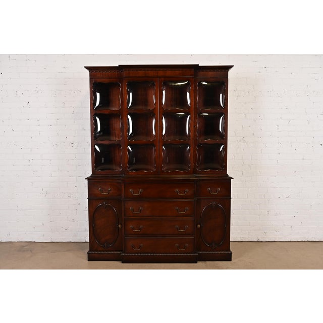 A beautiful Georgian or Chippendale style breakfront bookcase or dining cabinet with drop front secretary desk In the...