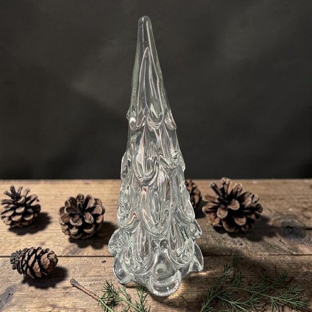 This product is a hand-blown Christmas tree made of clear glass by artisans in Italy. Standing at 12 inches tall, this...