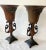 Vintage Pair of Neoclassical Borghese Style Metal Vases. These vases feature an exquisite frame with handles and a...