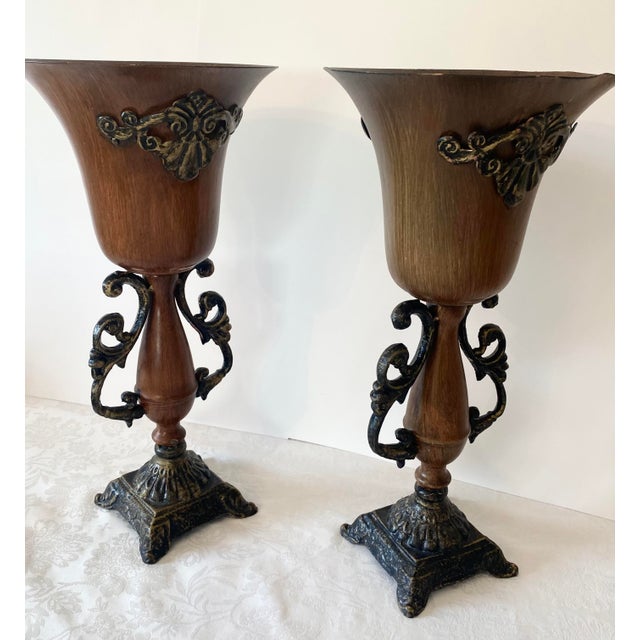Vintage Pair of Neoclassical Borghese Style Metal Vases. These vases feature an exquisite frame with handles and a...