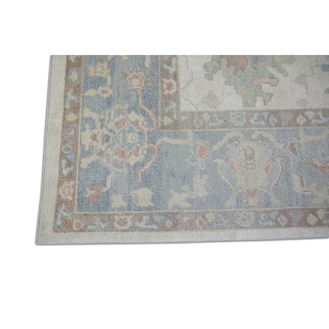 This modern Turkish Oushak rug is a stunning piece of art that has been handwoven using traditional techniques by skilled...