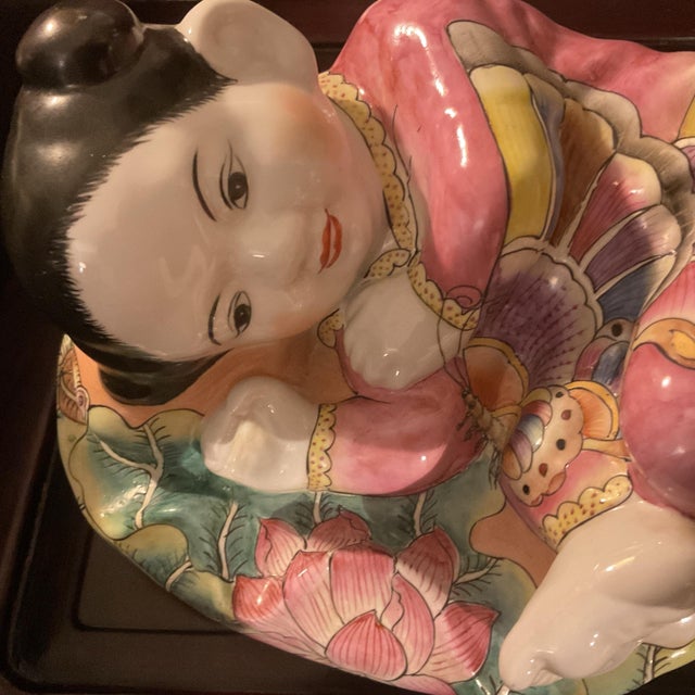Mid-Century ceramic little girl resting on a pillow. It is very colorful and in great condition.