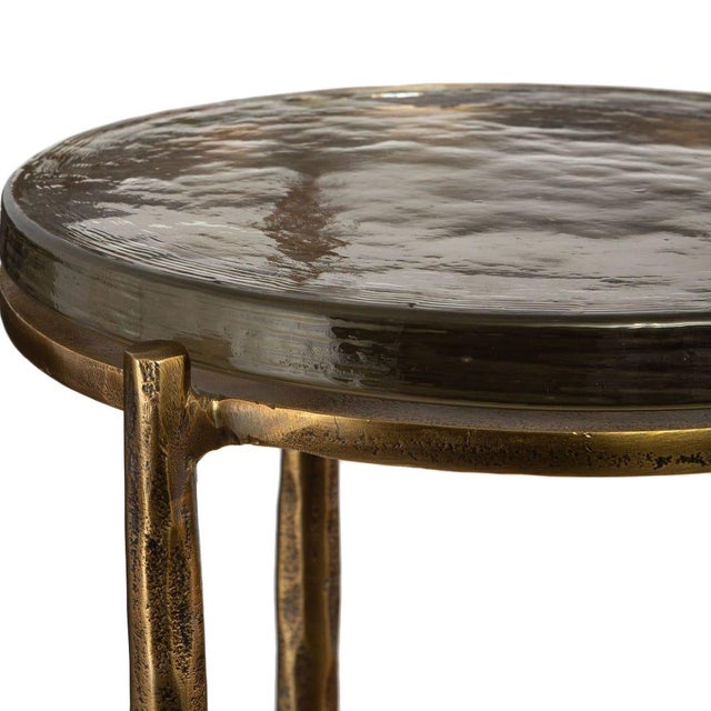 This accent table pairs a richly textured recycled glass top in smoky brown tones with a hand-finished cast aluminum base...