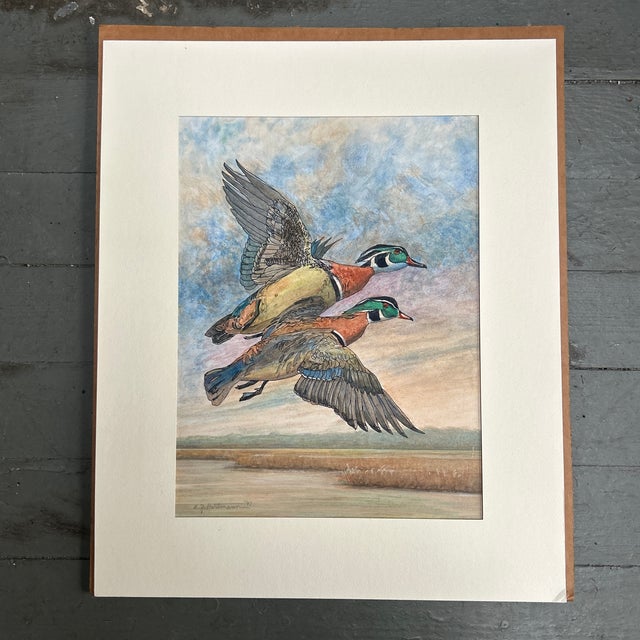 1990’s “two male wood ducks in flight over marsh” watercolor painting / pen drawing laid on matboard. Measures...