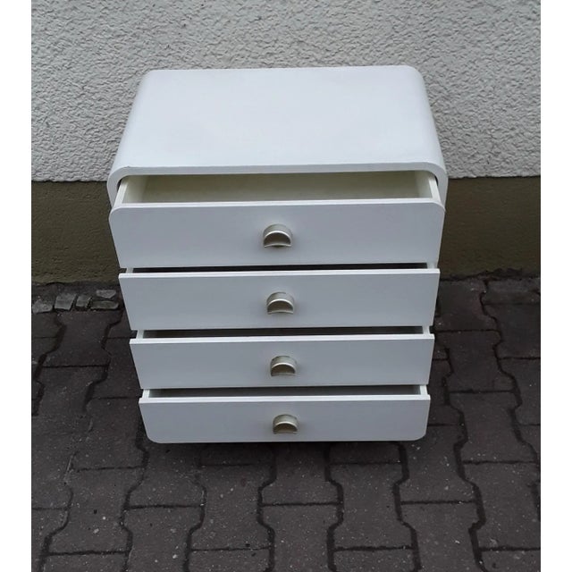 Small vintage chest of four drawers, pillar chest of drawers with rounded corners, with white Formica coating, four silver...
