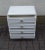 Small vintage chest of four drawers, pillar chest of drawers with rounded corners, with white Formica coating, four silver...