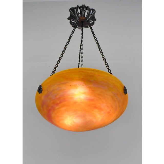 Daum freres & Louis Majorelle A wonderful French art deco hanging fixture in wrought iron with a Daum bowl in mottled...