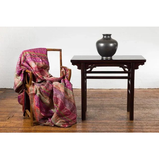 A Chinese Qing Dynasty Ming style yumu wood wine console table from the 19th century, with carved spandrels, humpback...