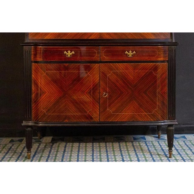 A fine Italian bookcase cabinet with brass finishes in excellent vintage condition.